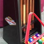 Pool table rack with q-sticks and accessories.