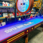Shuffleboard game with custom branding ready for rental delivery to Super Bowl Santa Clara San Francisco by Video Amusement