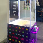 Wonder Claw with custom branding and attractive LED lights stands out at a trade show Video Amusement Los Angeles